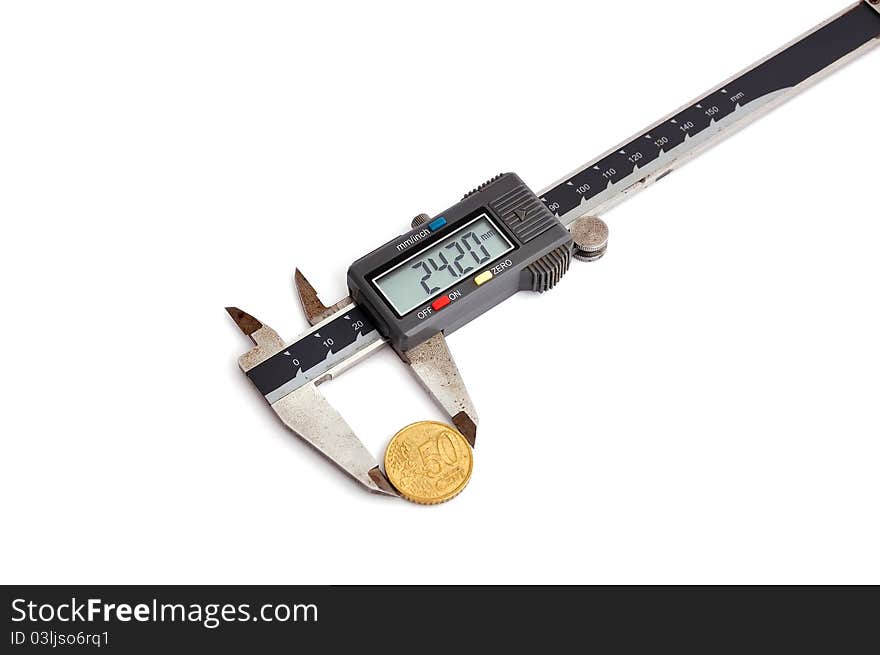 Electronic calipers and coin on a white background