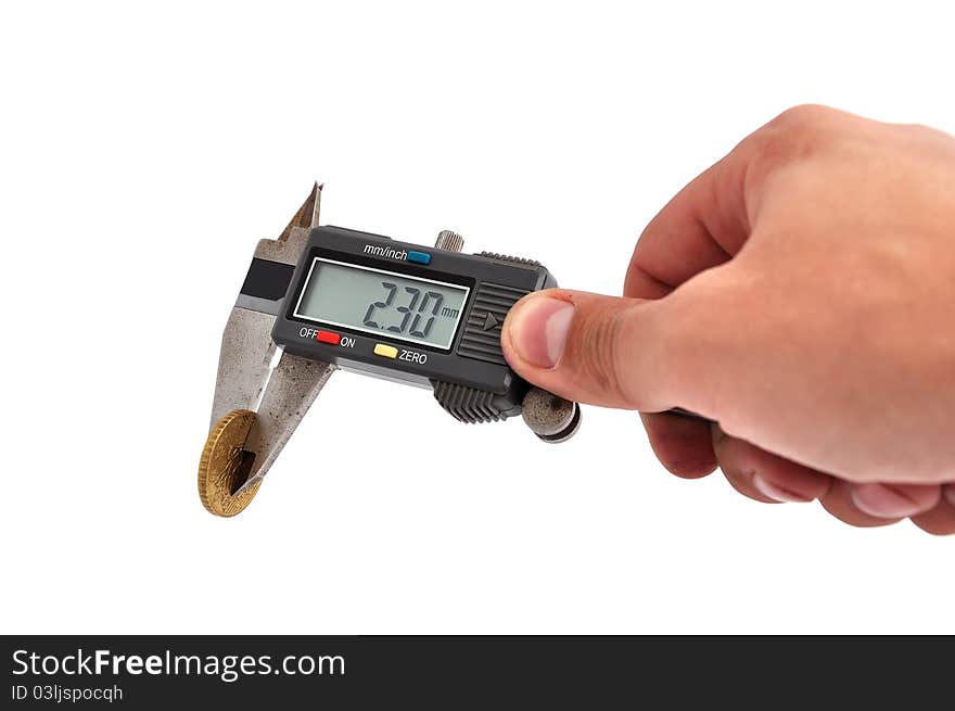 Electronic calipers and coin on a white background