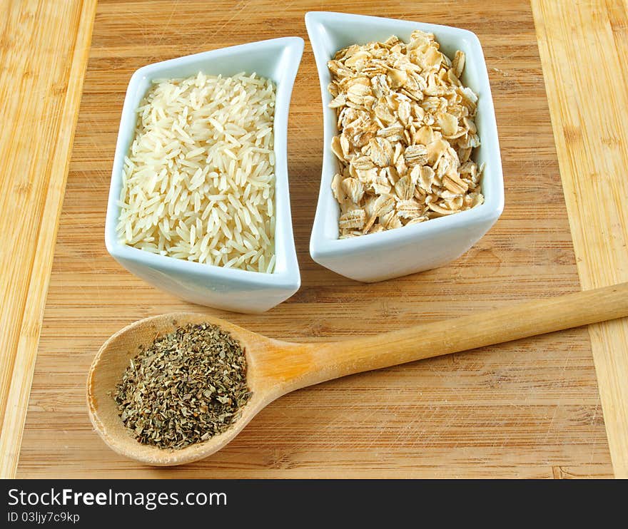 Rice, oats and herbs on the wooden board. Rice, oats and herbs on the wooden board