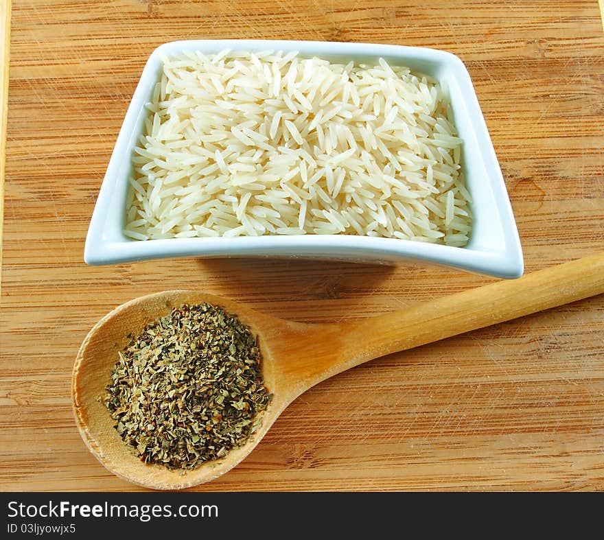 Rice and herbs on the wooden board