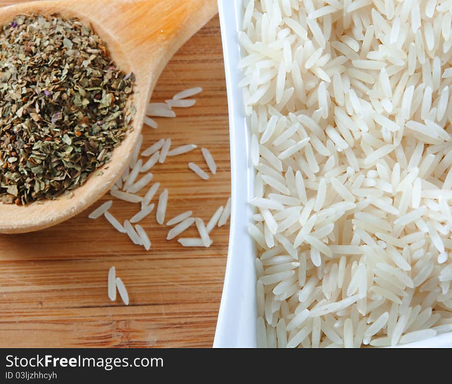 Rice and herbs on the wooden board