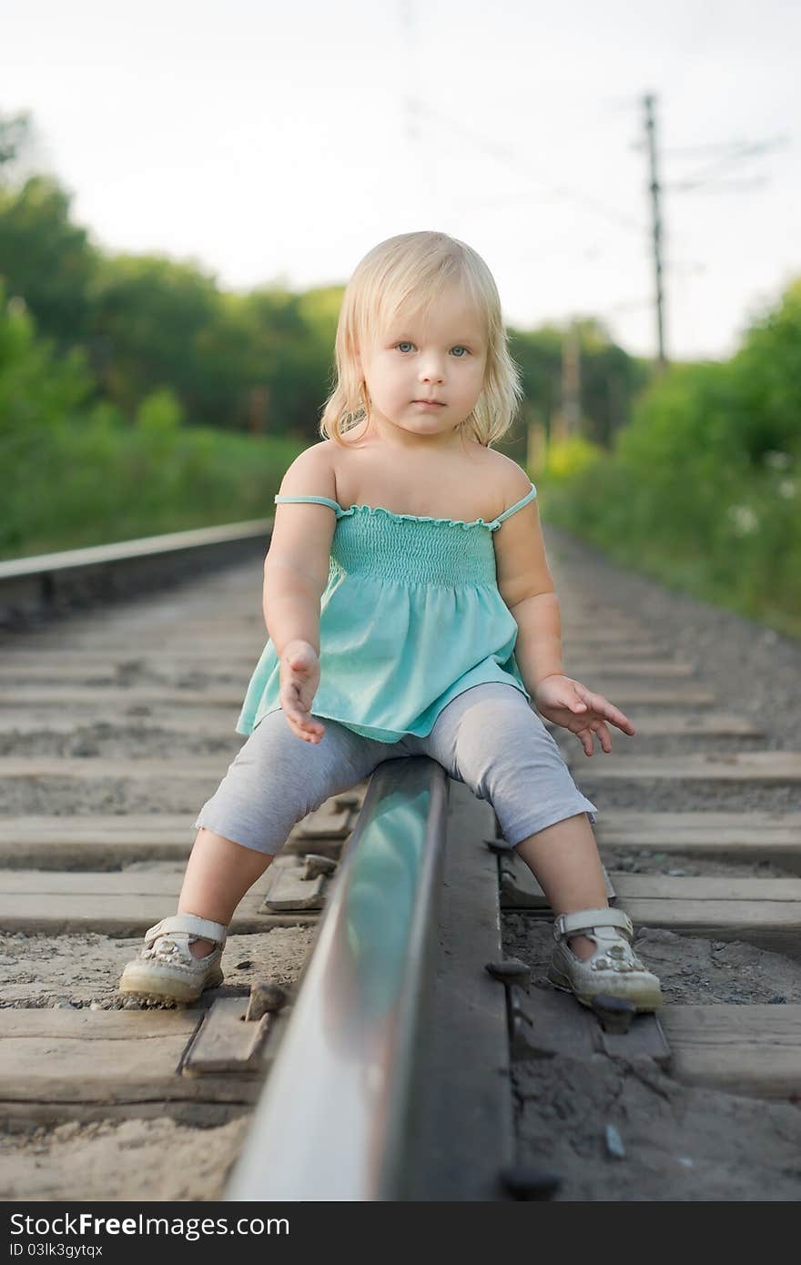 Adorable girl sit on rail look to camera