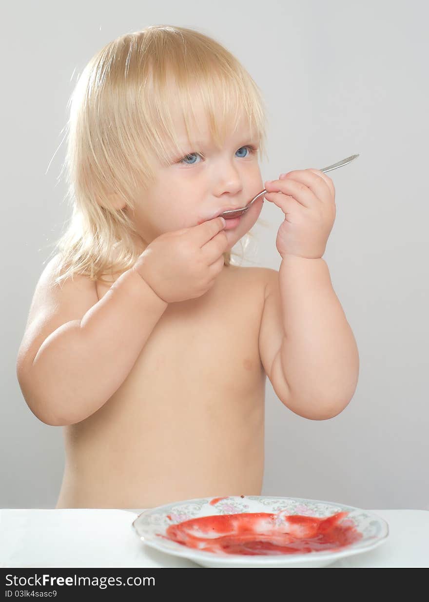 Adorable Girl Eat Strawberry Jam With Spoon