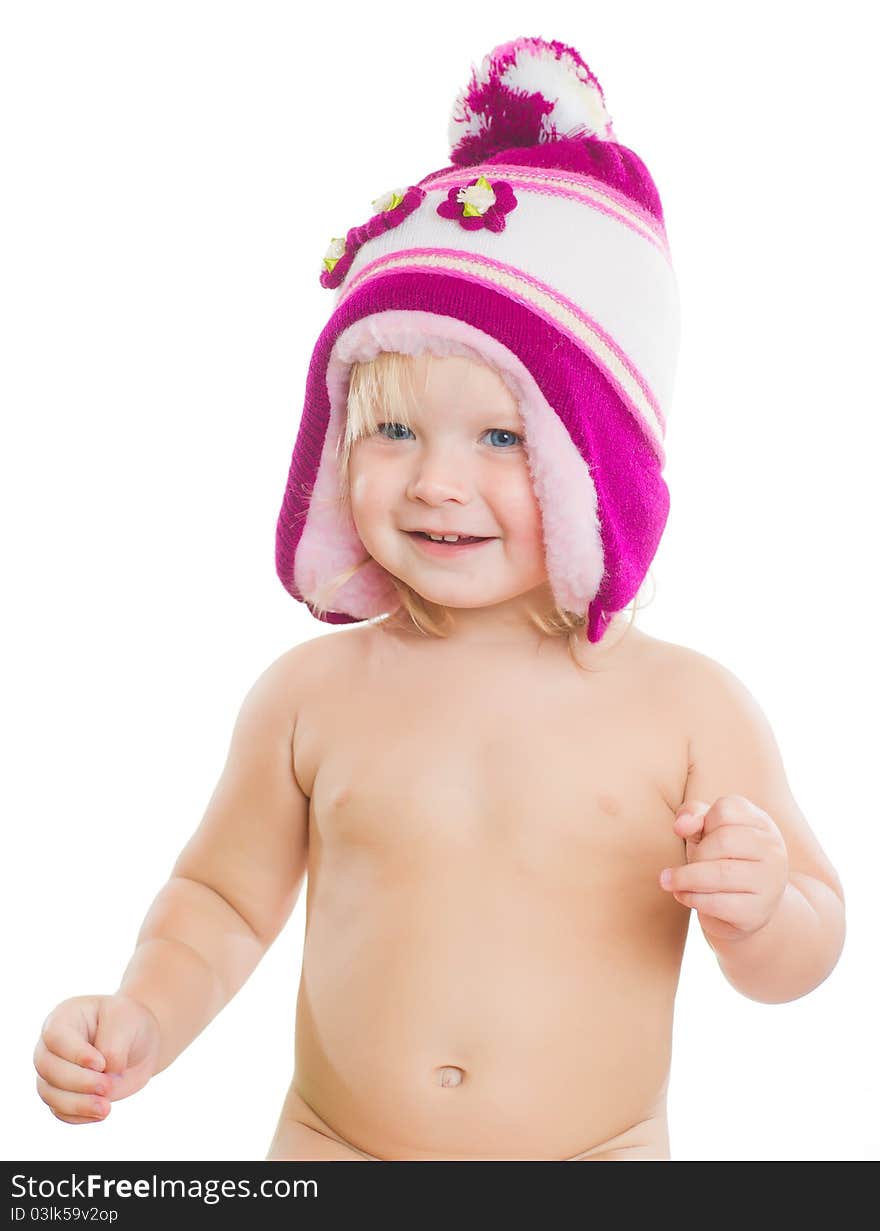 Adorable toddler girl putting on beautiful winter hat on head. Adorable toddler girl putting on beautiful winter hat on head