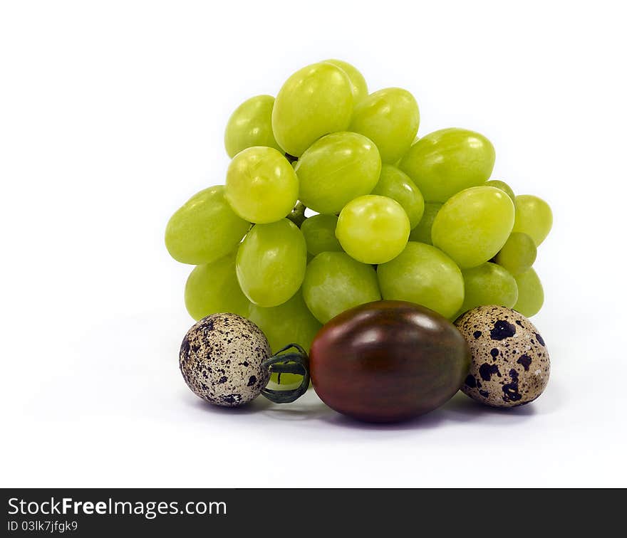 In the shot light box was used and the following food ingedients isolated on white background: quail eggs, grape and a rare strain of a black small tomato selected in Israel. In the shot light box was used and the following food ingedients isolated on white background: quail eggs, grape and a rare strain of a black small tomato selected in Israel