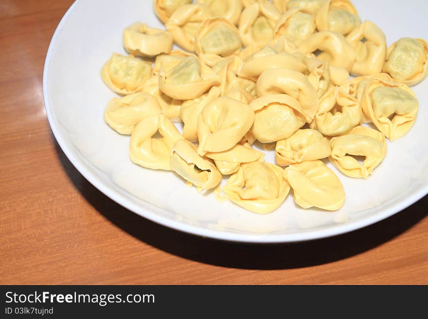 Tortellini with meat in a white dish