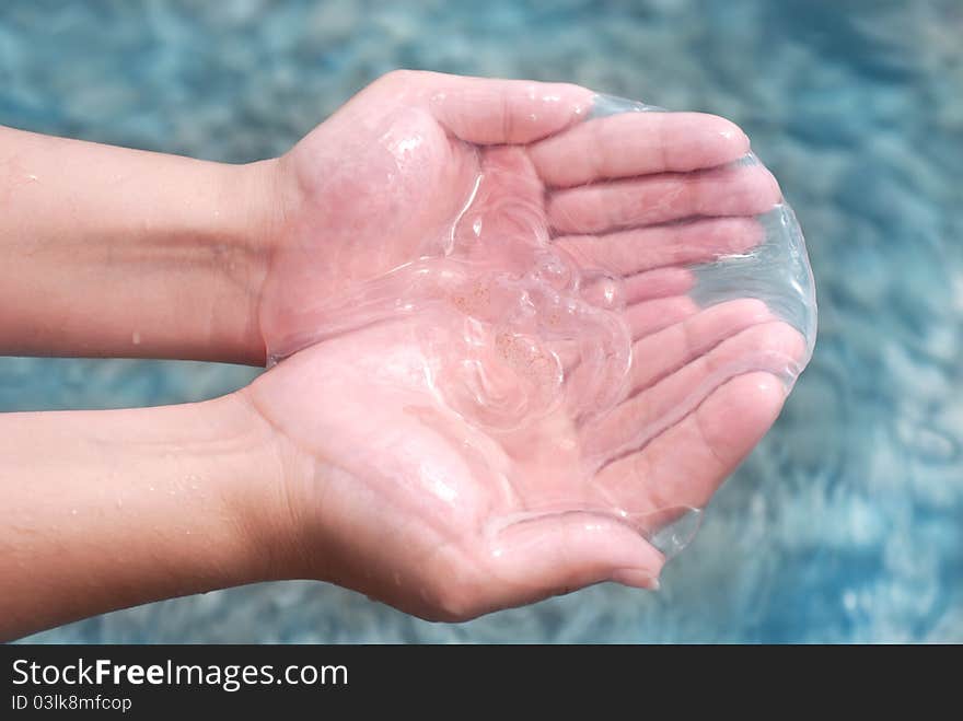 Jellyfish in hand against the blue sea