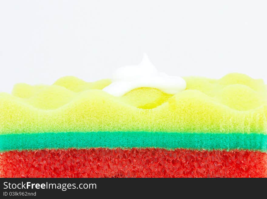 Beautiful tricolor sponge to wash the body on a white background. Beautiful tricolor sponge to wash the body on a white background