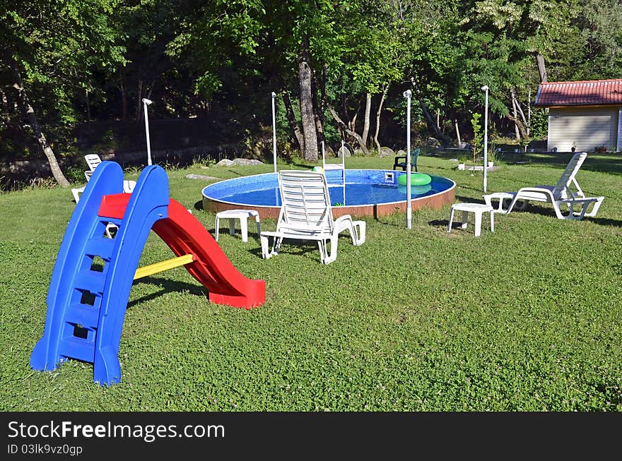 Children playing place with swimming pool near the forest. Children playing place with swimming pool near the forest