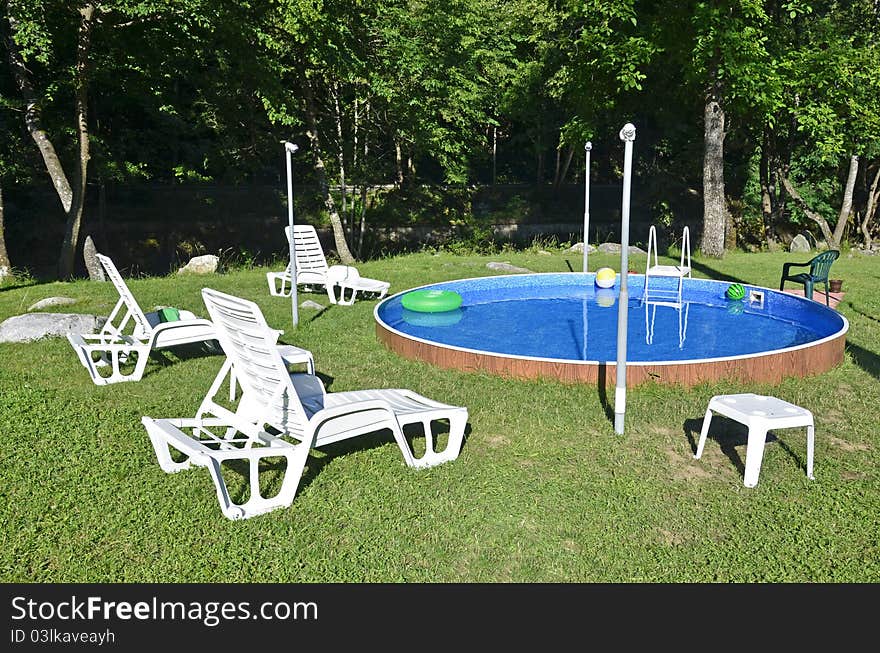 Children playing place with swimming pool near the forest. Children playing place with swimming pool near the forest