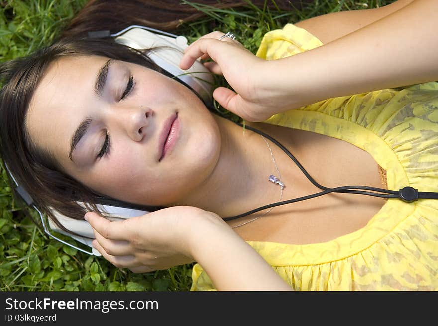 Young woman listening to music outdoors. Young woman listening to music outdoors