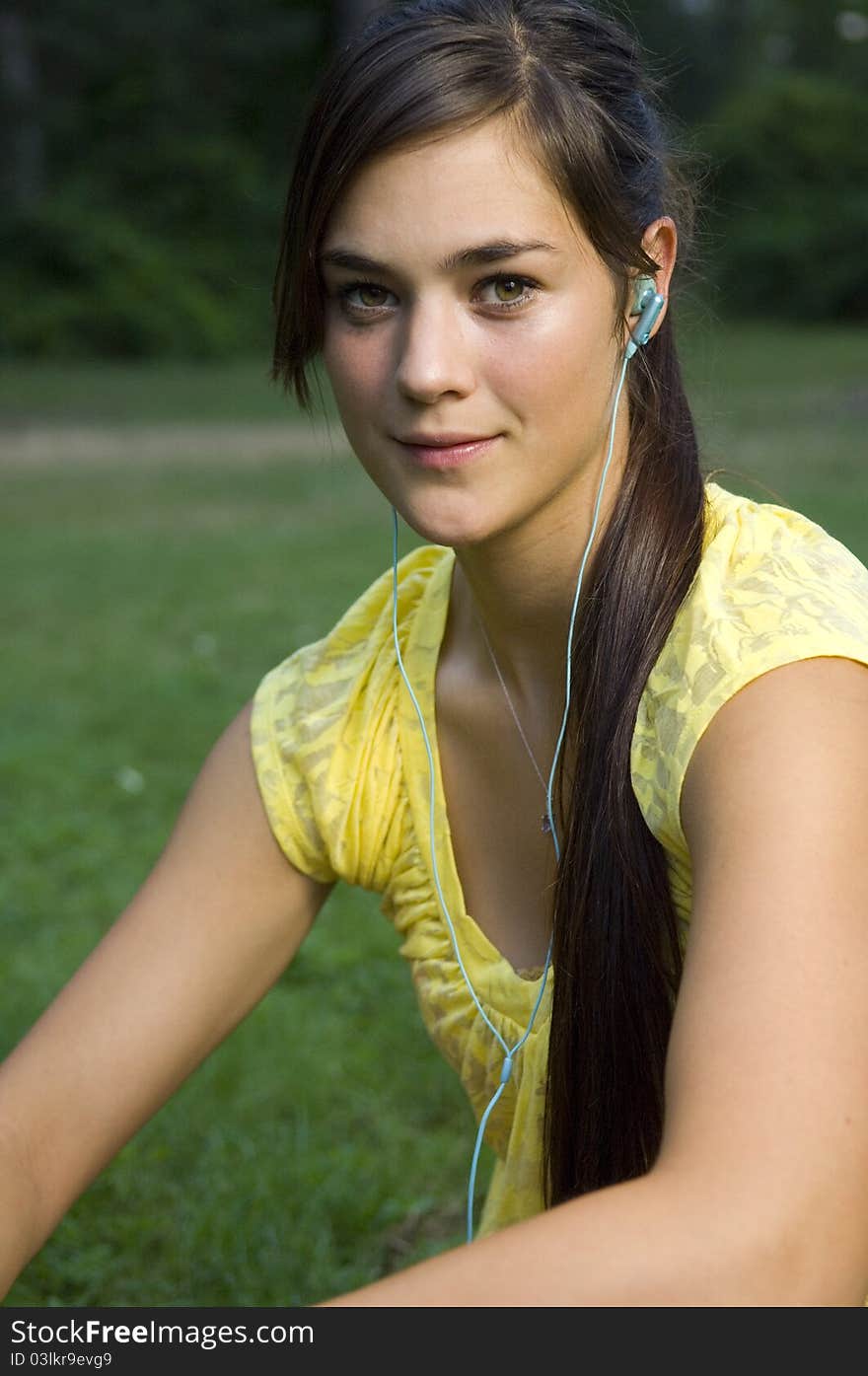 Young woman listening to music outdoors. Young woman listening to music outdoors