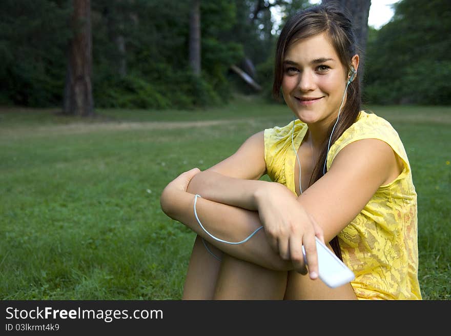 Young woman listening to music outdoors. Young woman listening to music outdoors