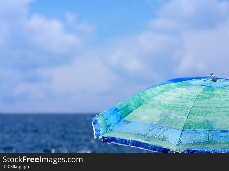 Beach umbrella close up against a sea landscape