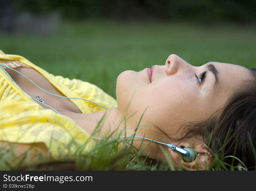 Young woman listening to music outdoors. Young woman listening to music outdoors