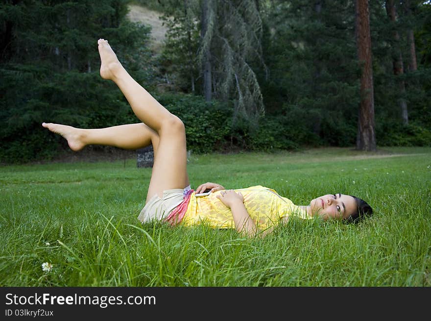 Young woman listening to music outdoors. Young woman listening to music outdoors