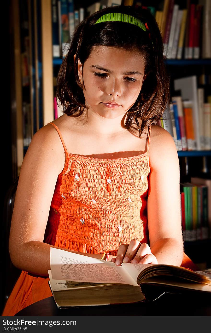 Young girl reading in library