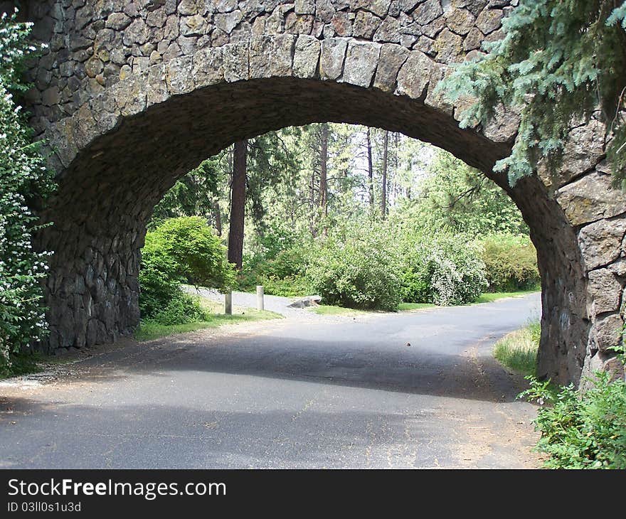 A road going through a stone tunnel.