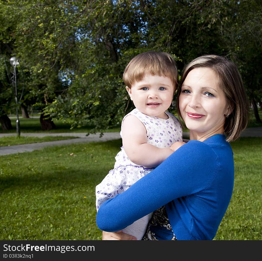 The portrait of the baby and mother in the park. The portrait of the baby and mother in the park