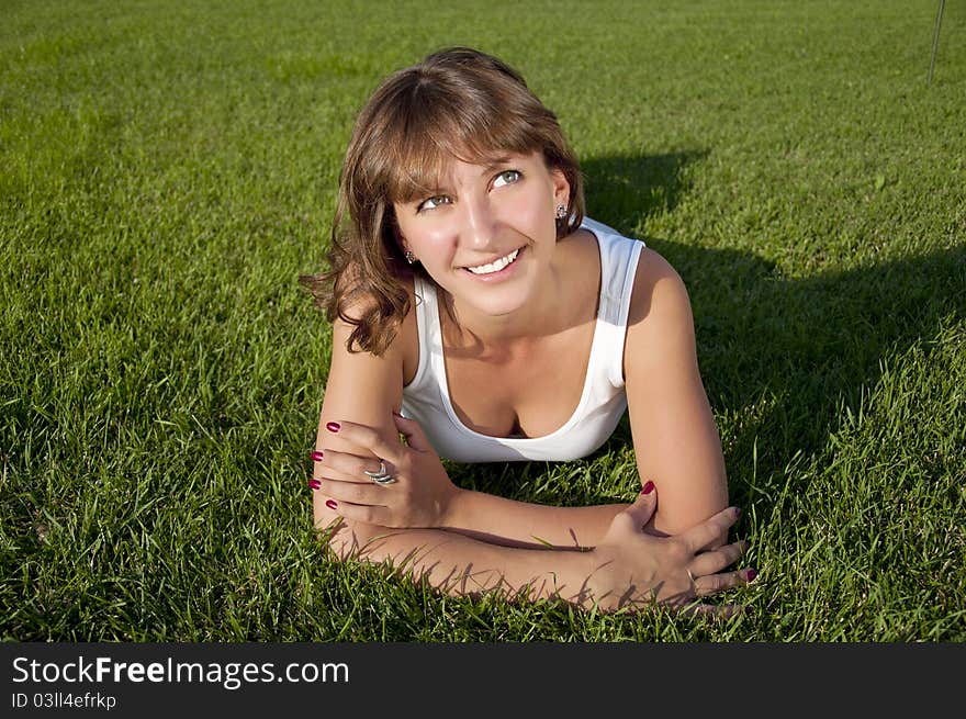 Beautiful Young Woman Smiling On Grass Field