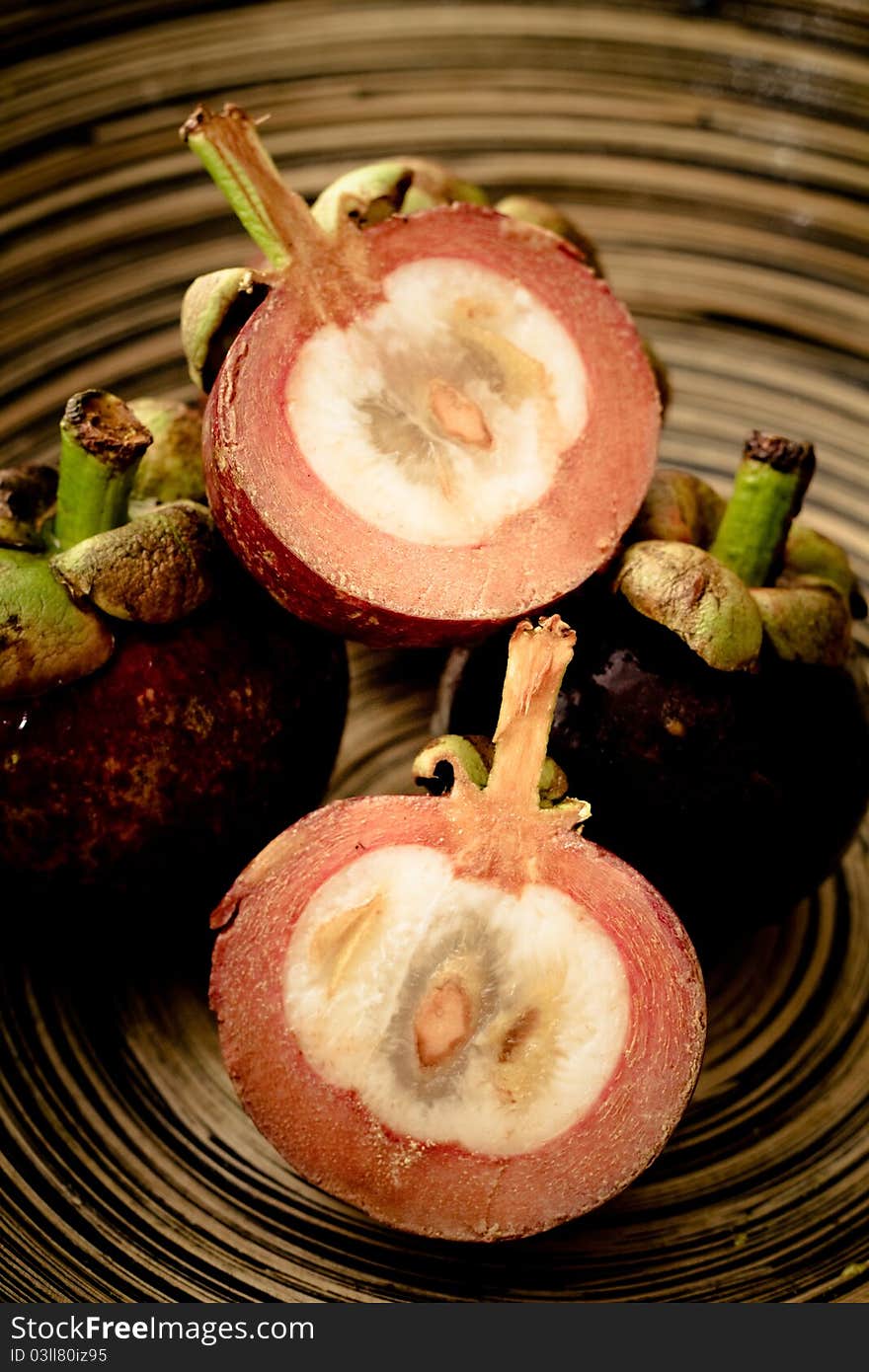 Mangosteens in a wooden bowl