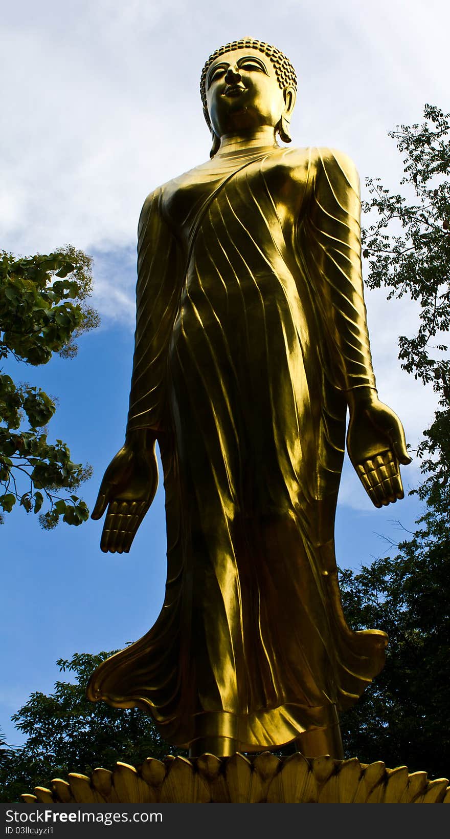 Golden Buddha statue stands.