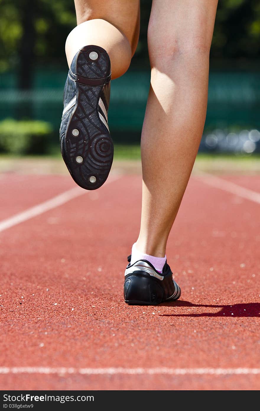 Young woman in sprinting position