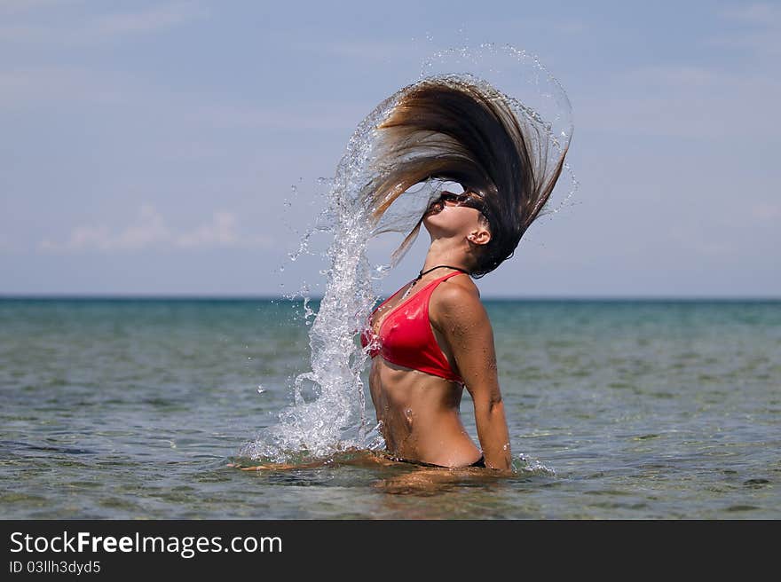 Girl splashing water with long hair