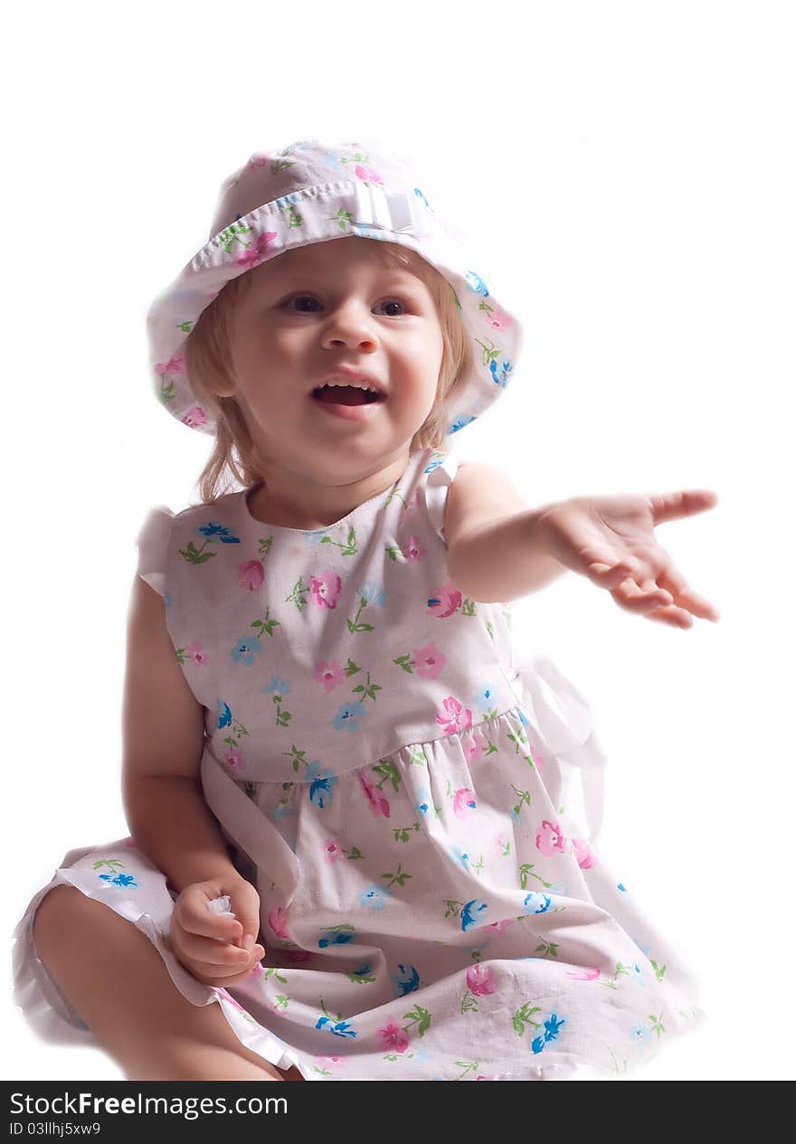 The little girl in a dress with arm outstretched on a white background