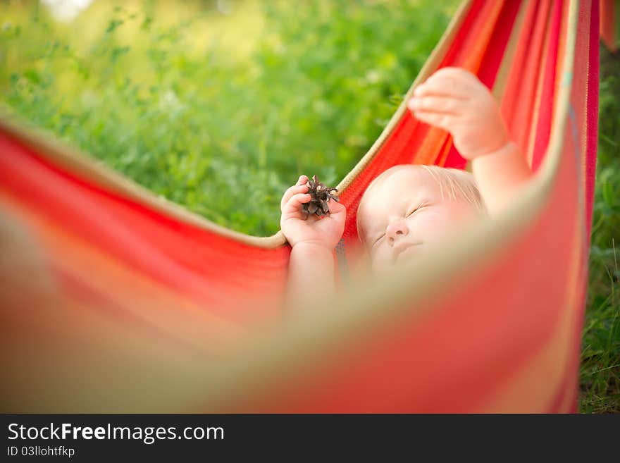 Adorable baby relaxing in hammock