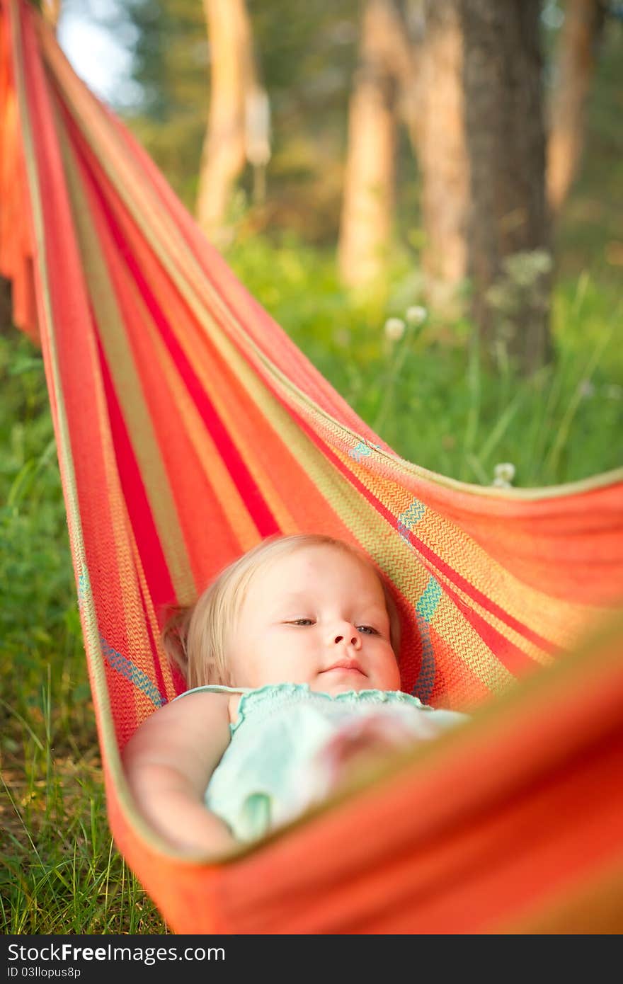 Adorable baby relaxing in hammock