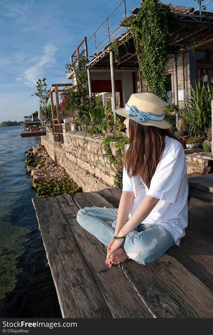 Dance girl standing on the edge of waterfront Erhai Lake in Yunnan, China side of the inn, closer to the water