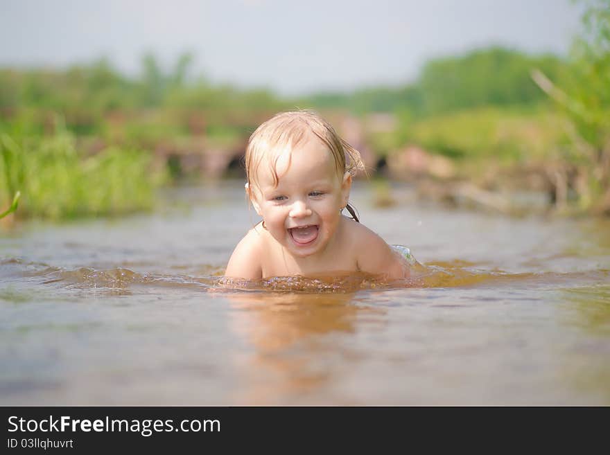 Adorable young baby swim in river. Adorable young baby swim in river