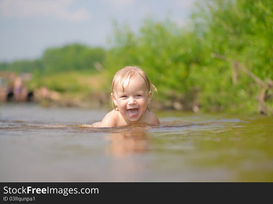 Adorable baby swim in river