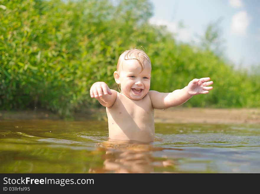 Adorable baby walk in river water