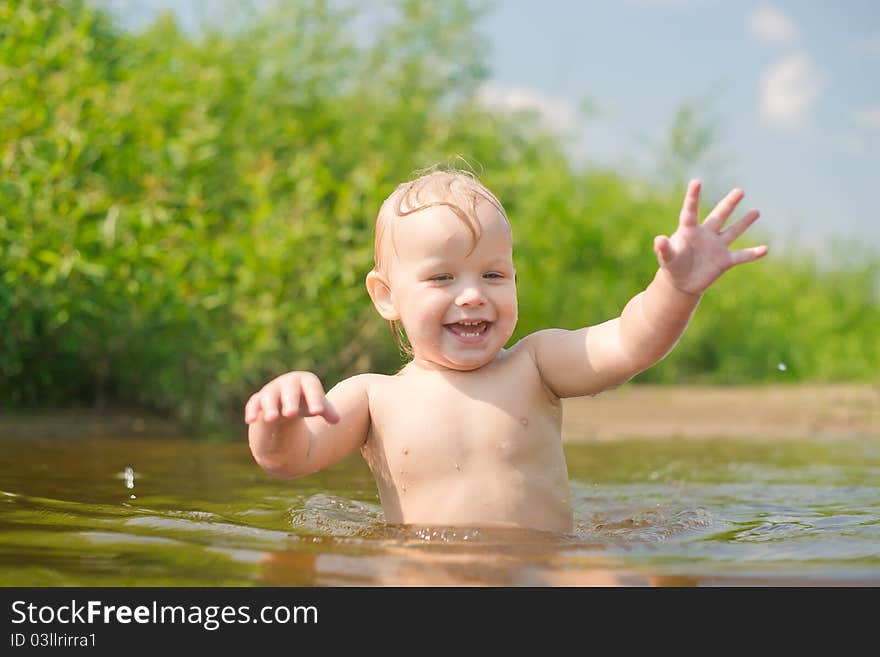 Adorable baby walk in river water. Adorable baby walk in river water