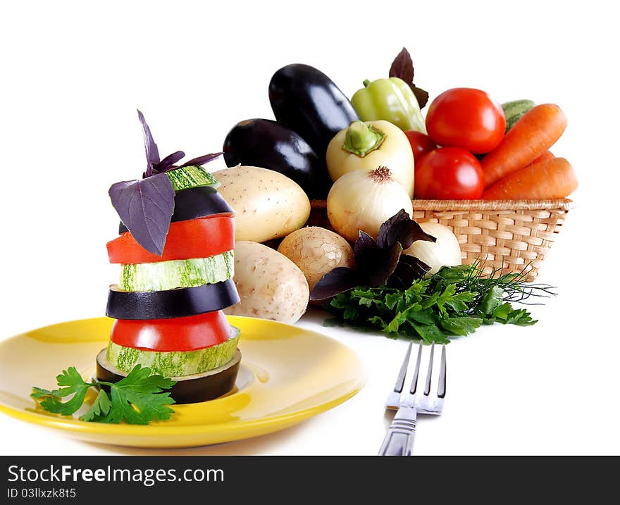 Fresh vegetable in the basket and vegetable snack on the yellow plate. Fresh vegetable in the basket and vegetable snack on the yellow plate