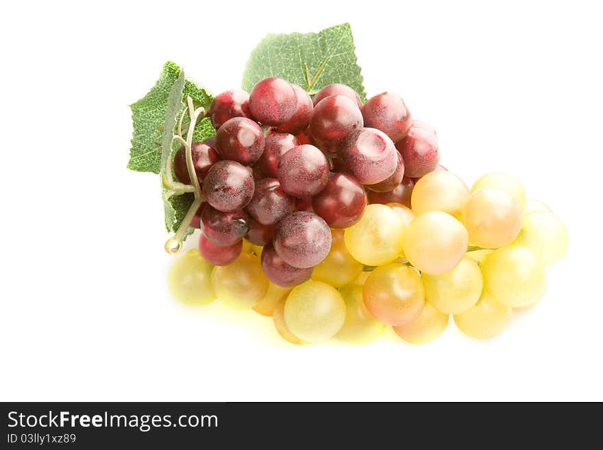 Red and white artificial grapes on a white background. Red and white artificial grapes on a white background