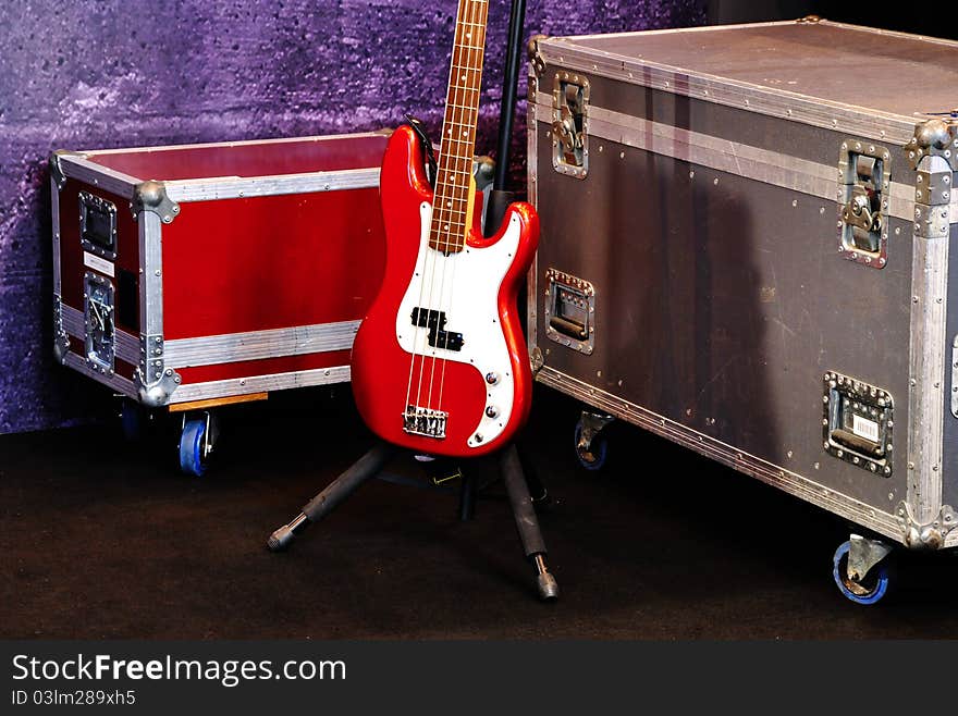 A red bass guitar on a stage