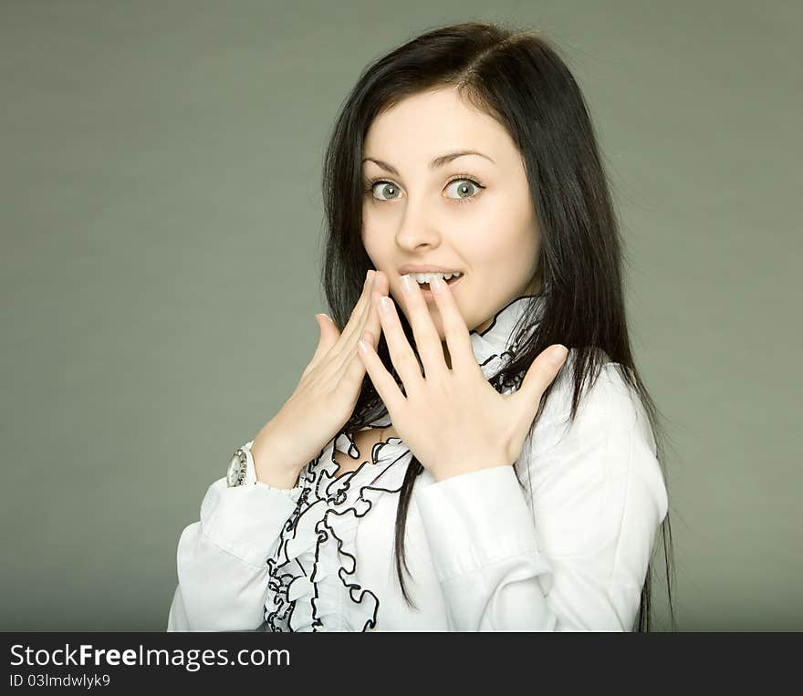 Beautiful brunette girl оn a gray background