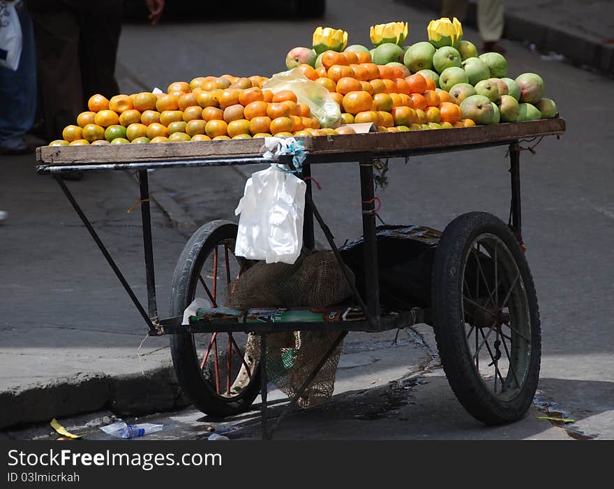 Clementines and Mangos on a cart. Clementines and Mangos on a cart