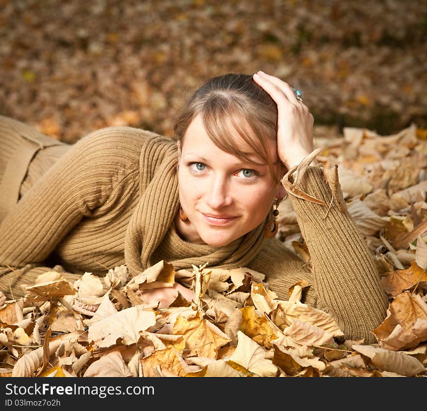 Young Woman In Autumn Leaves