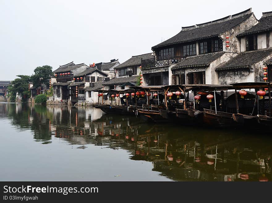 Old water town , some old boats on river， which  reflecte on the river. Old water town , some old boats on river， which  reflecte on the river