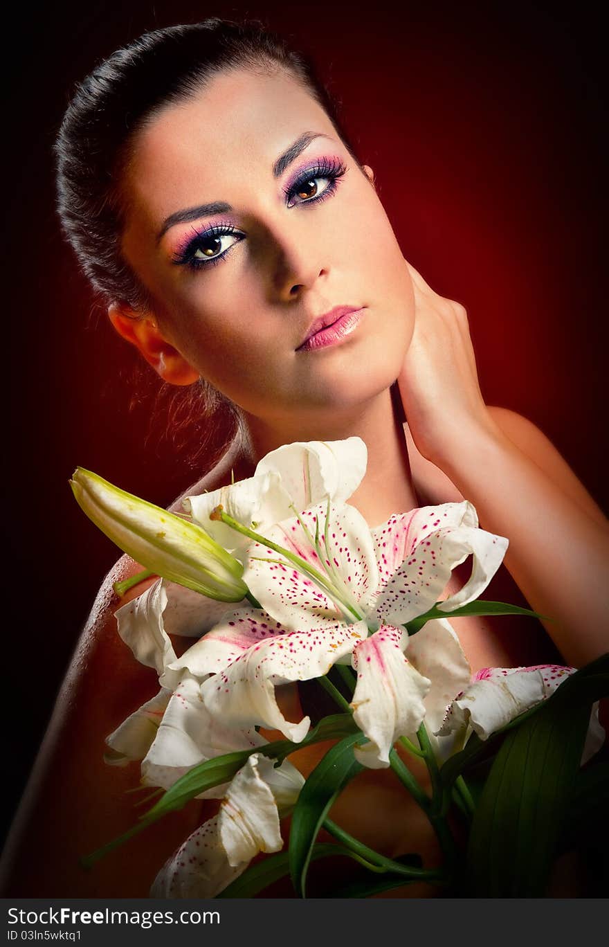 Beautiful young woman with white lily