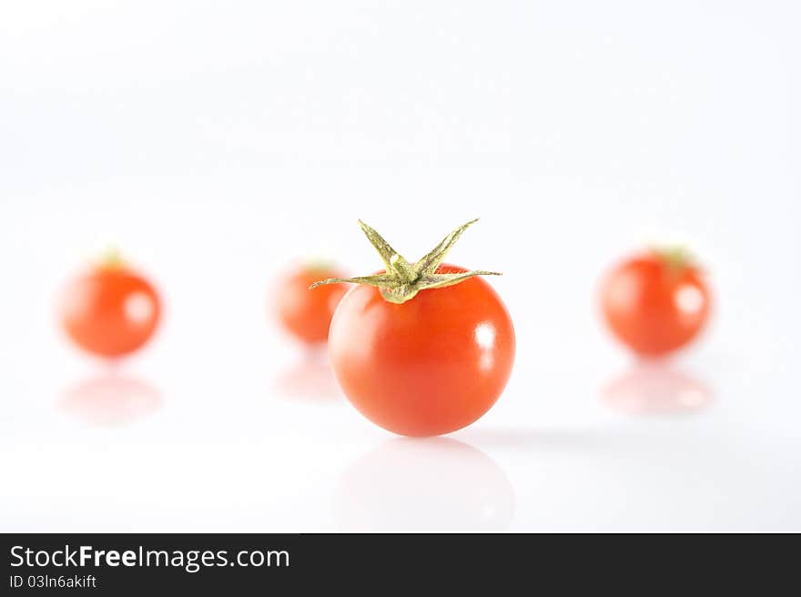 Photography of a tomato in front of 3 tomatos. Photography of a tomato in front of 3 tomatos.