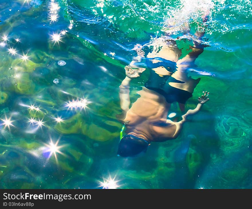 Swimmer dived into the sea water. Swimmer dived into the sea water