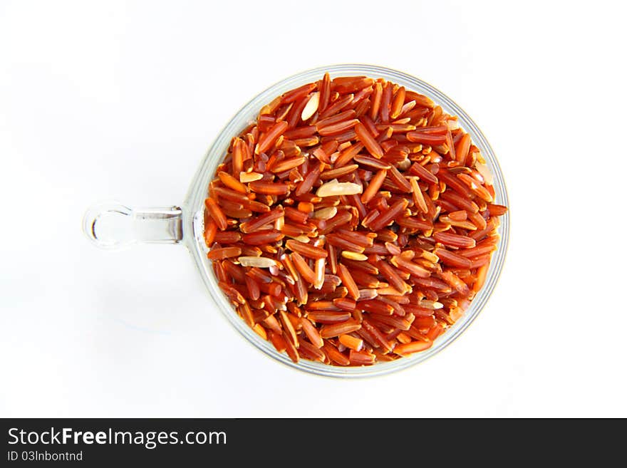 Red jasmine rice and beaker on a white background