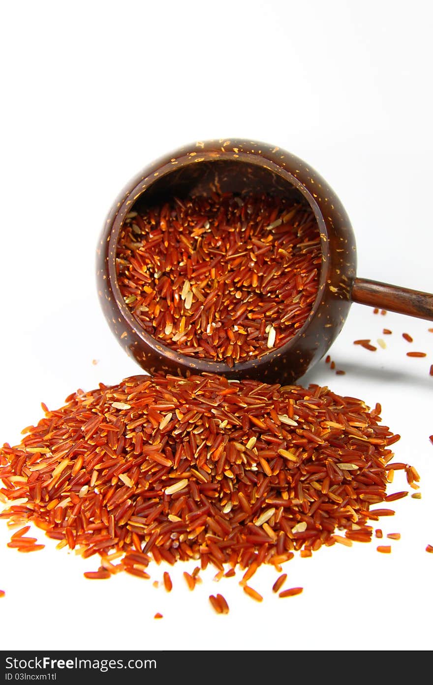 Red jasmine rice and beaker on a white background