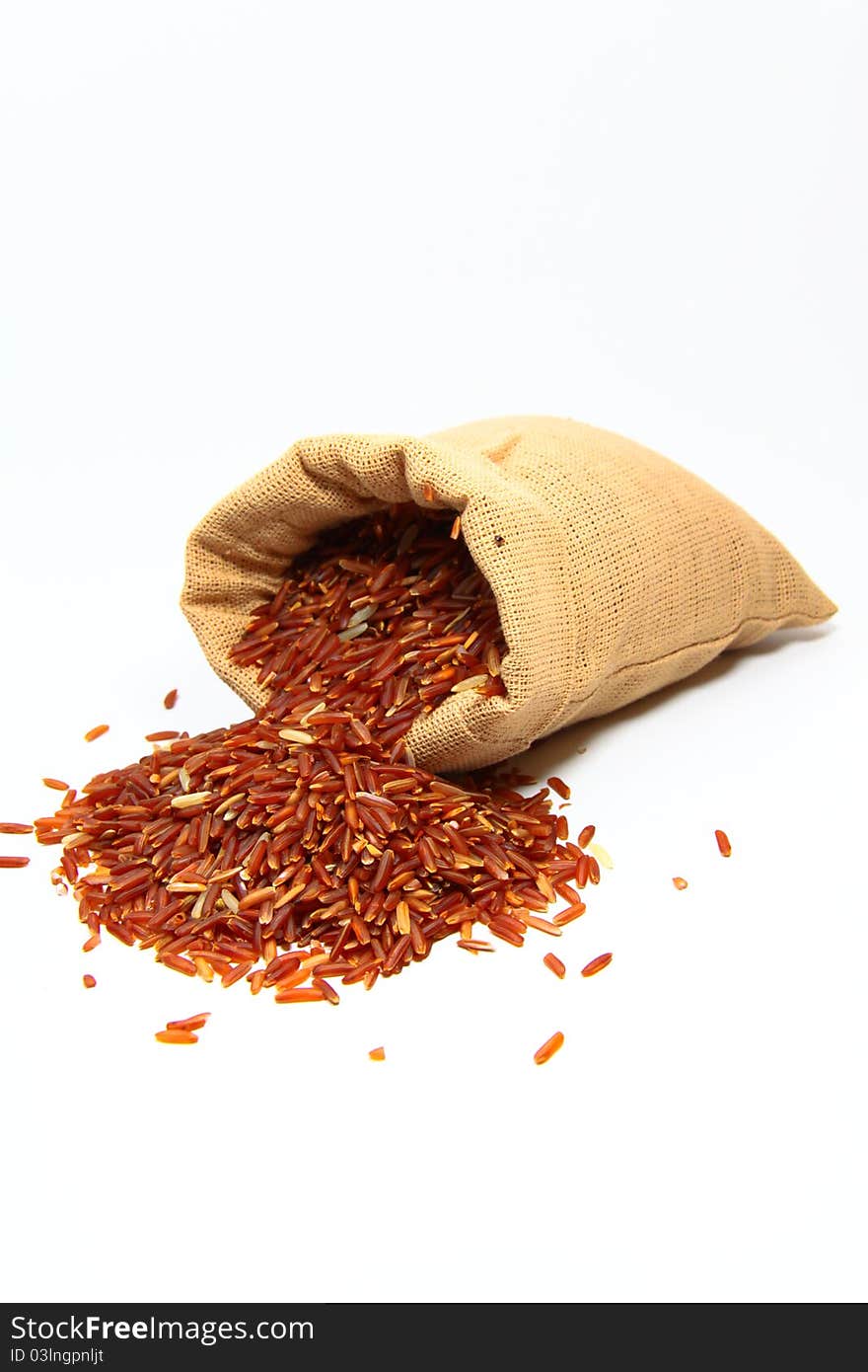 Red jasmine rice and beaker on a white background