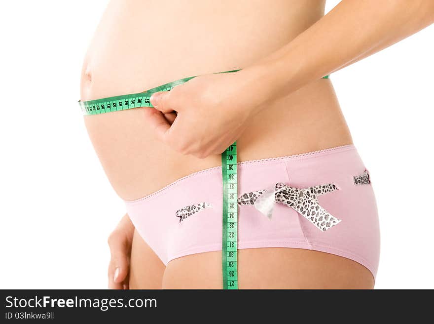 Pregnant woman is holding sewing meter